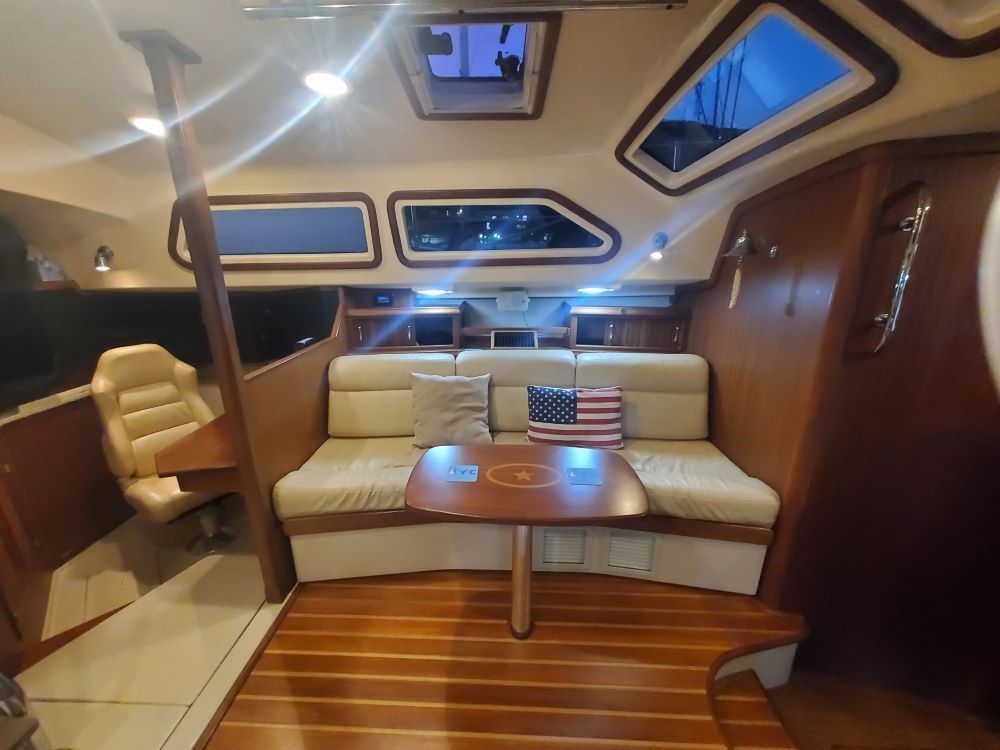 A living room on a boat with a couch and table