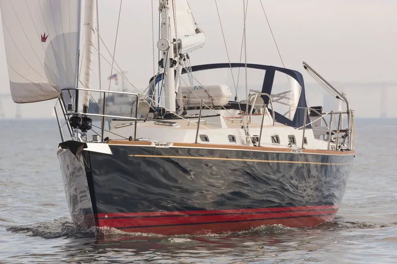 A sailboat is floating on top of a body of water.
