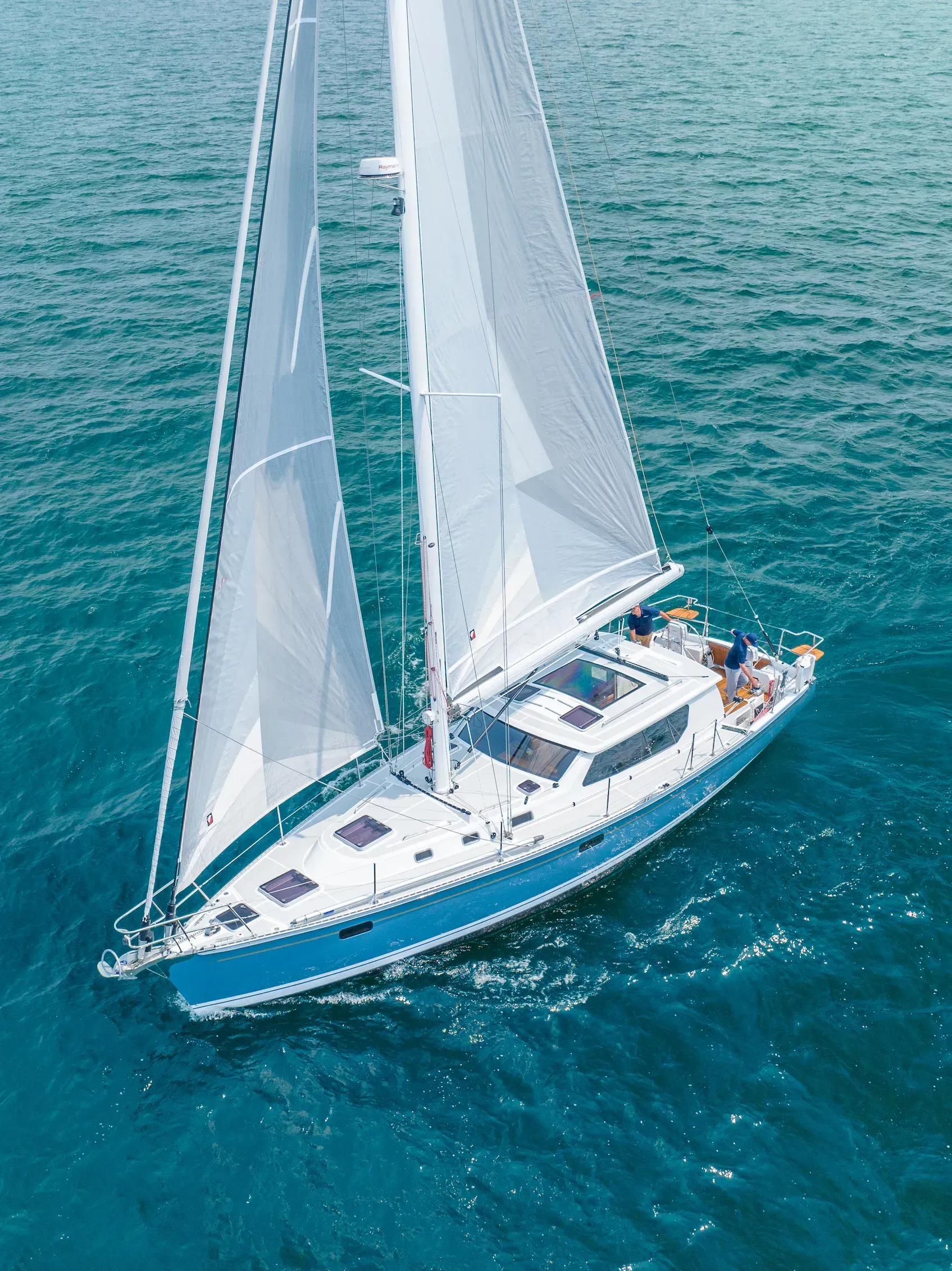 An aerial view of a sailboat in the ocean