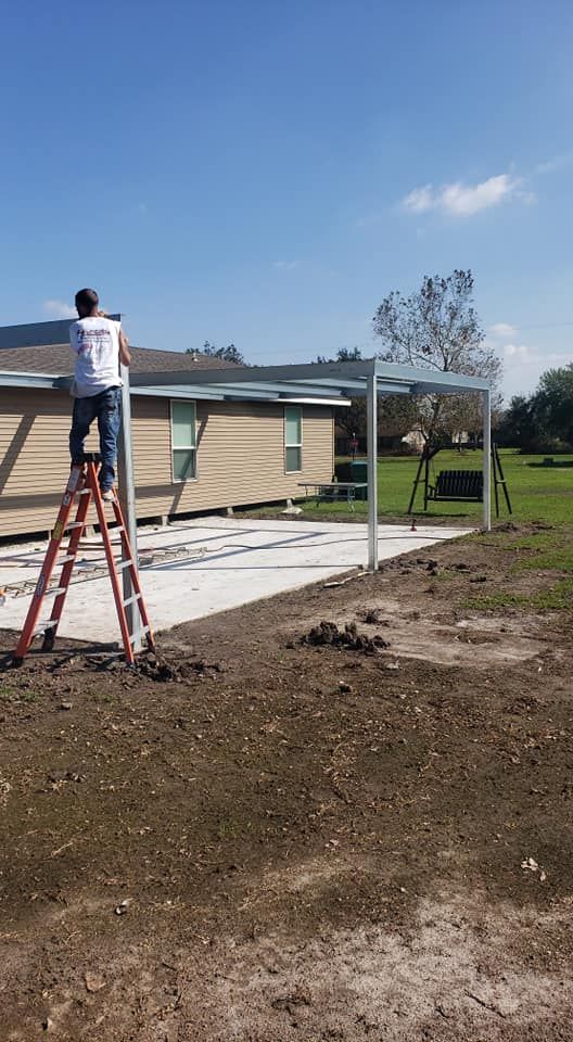 A man is standing on a ladder in front of a house.