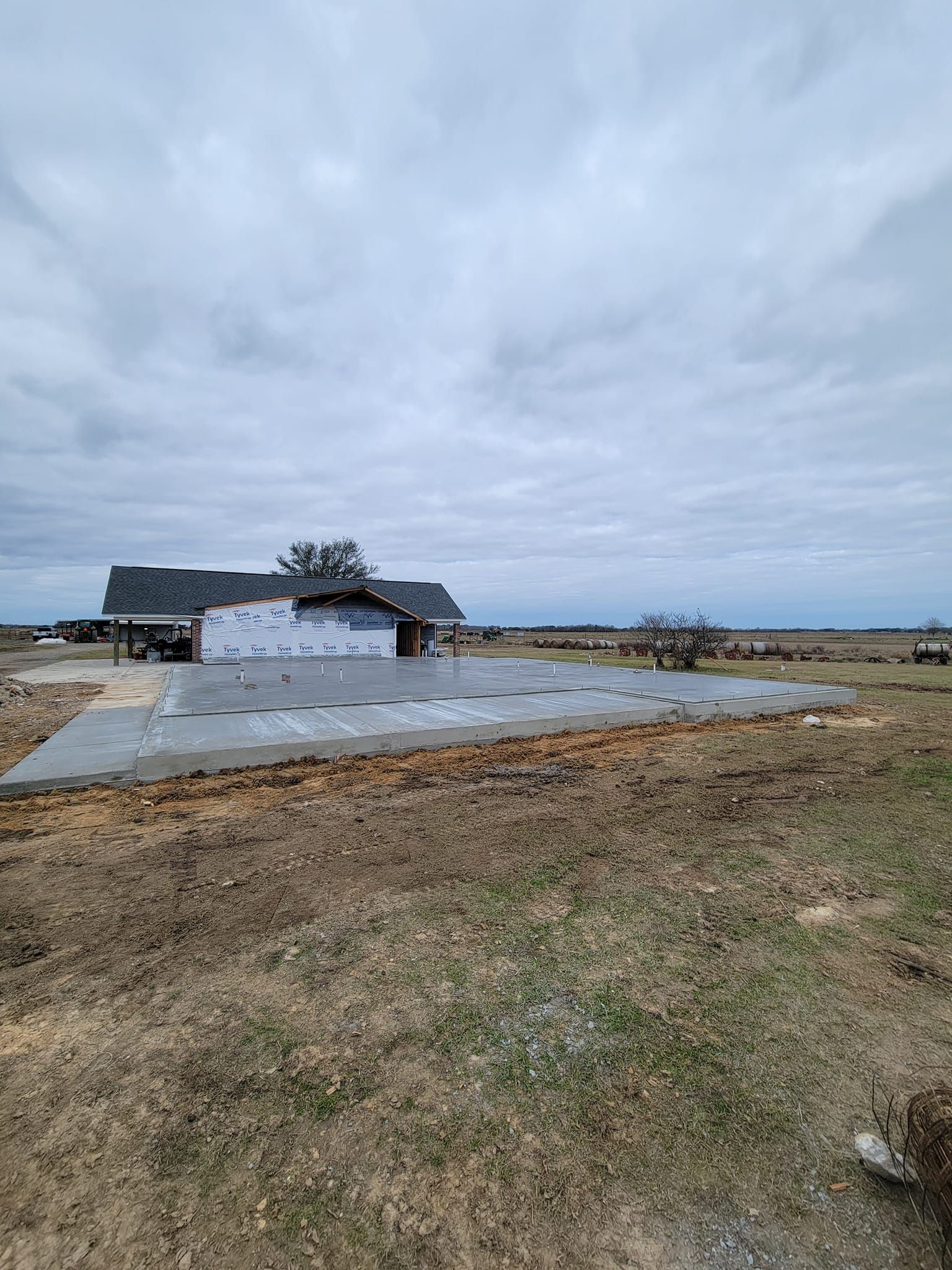 A house is being built in the middle of a field.