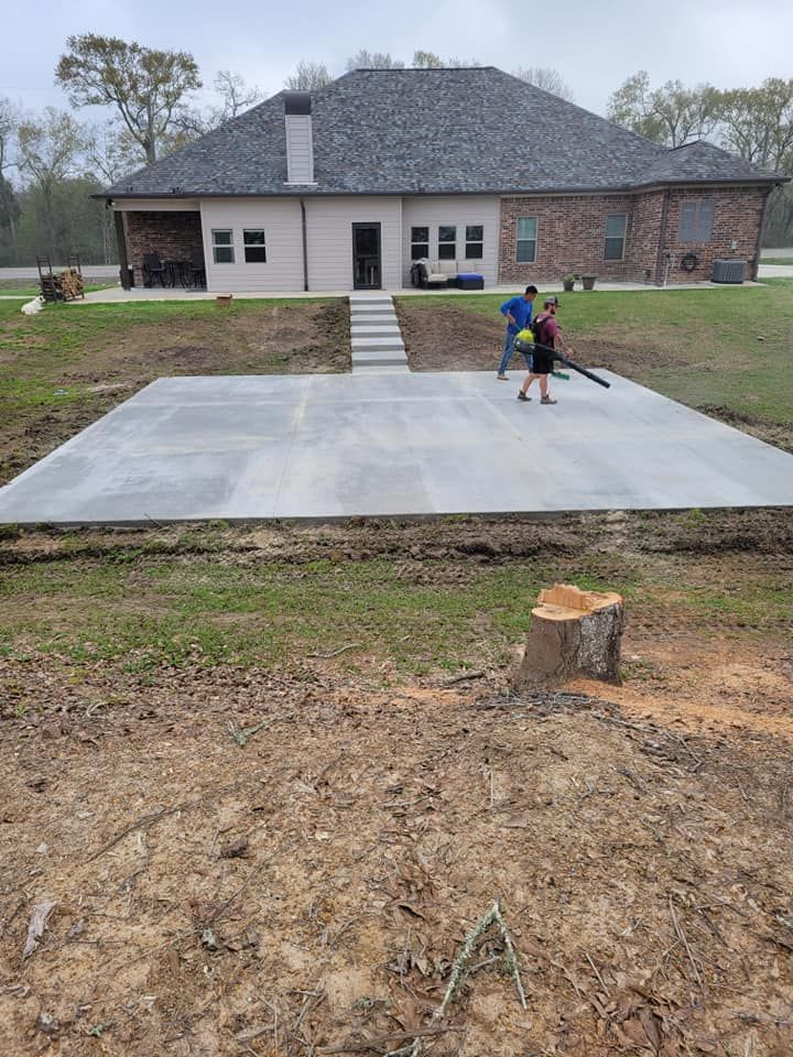 A concrete driveway is being built in front of a house.
