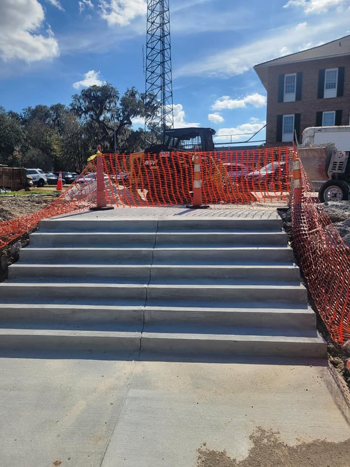 A concrete staircase is being built in front of a building.