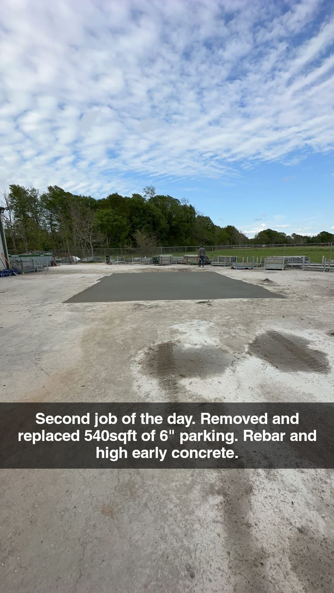 A picture of a construction site with a blue sky and trees in the background.
