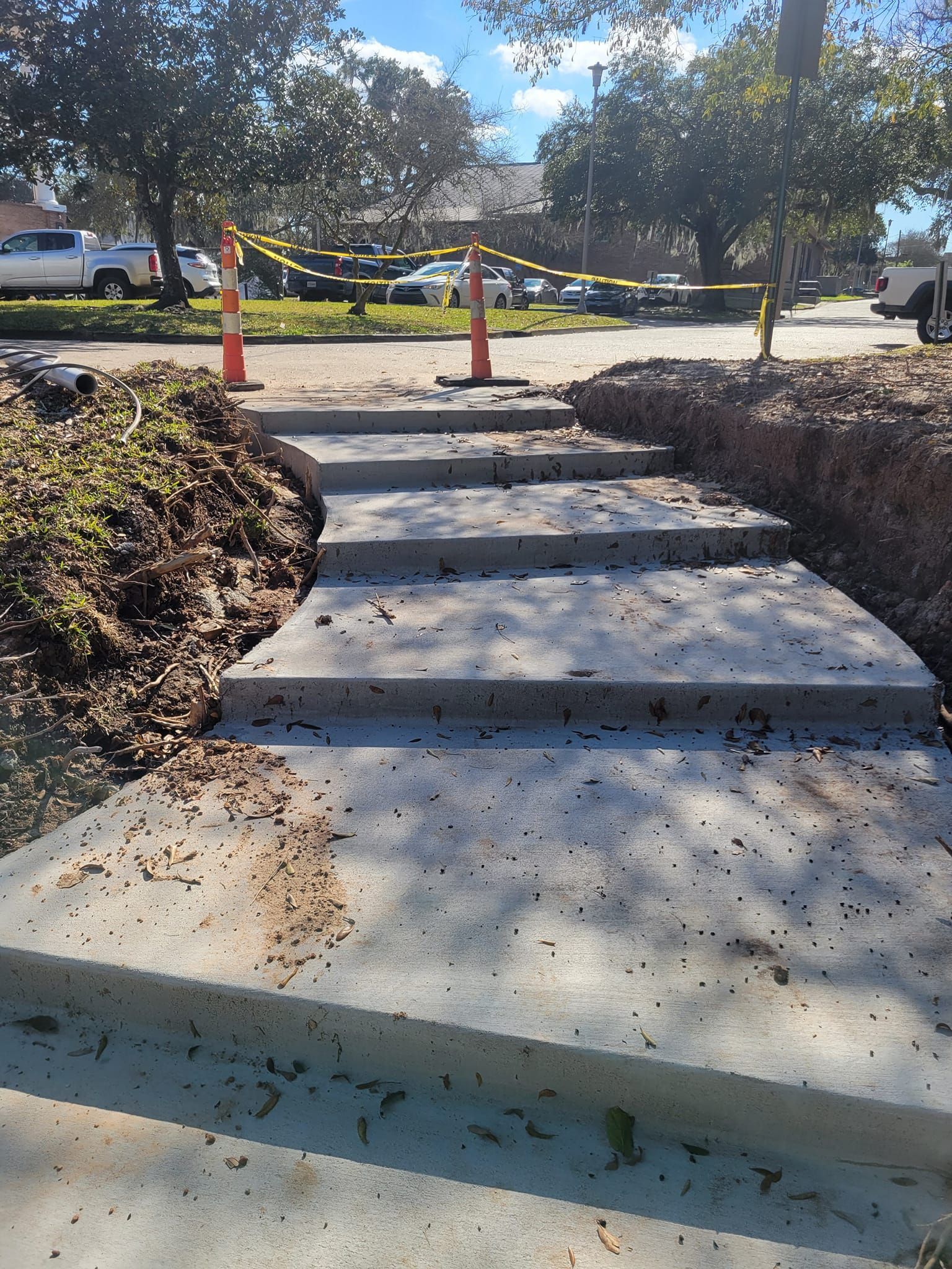 A set of concrete steps leading up to a parking lot