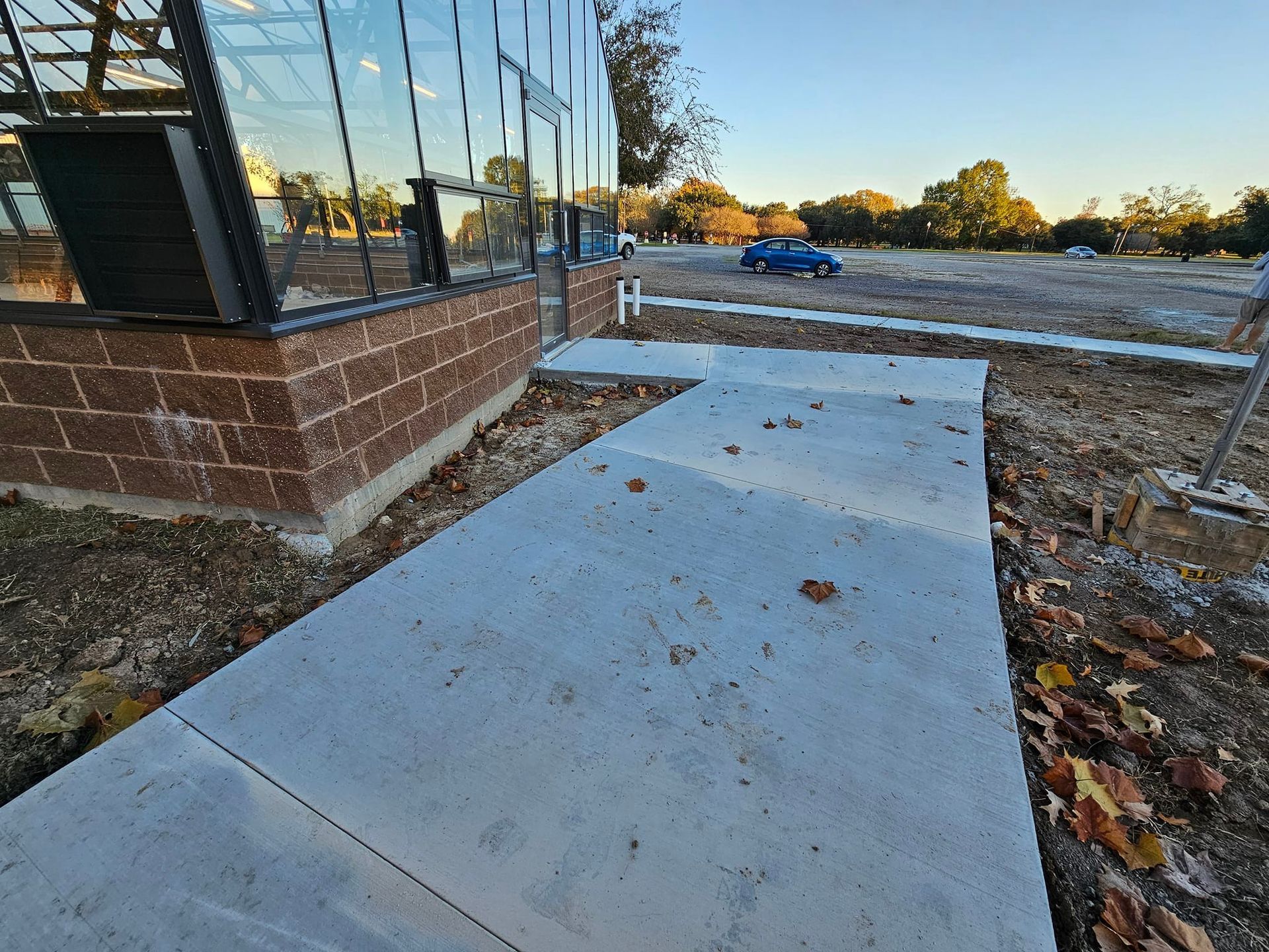 A concrete walkway is being built in front of a building.