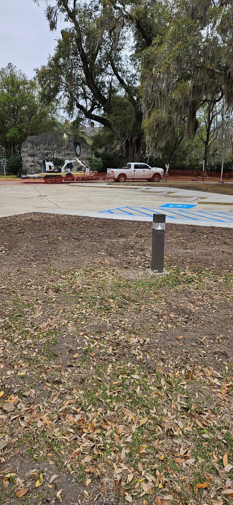 A parking lot with a handicapped parking spot in the middle of it.