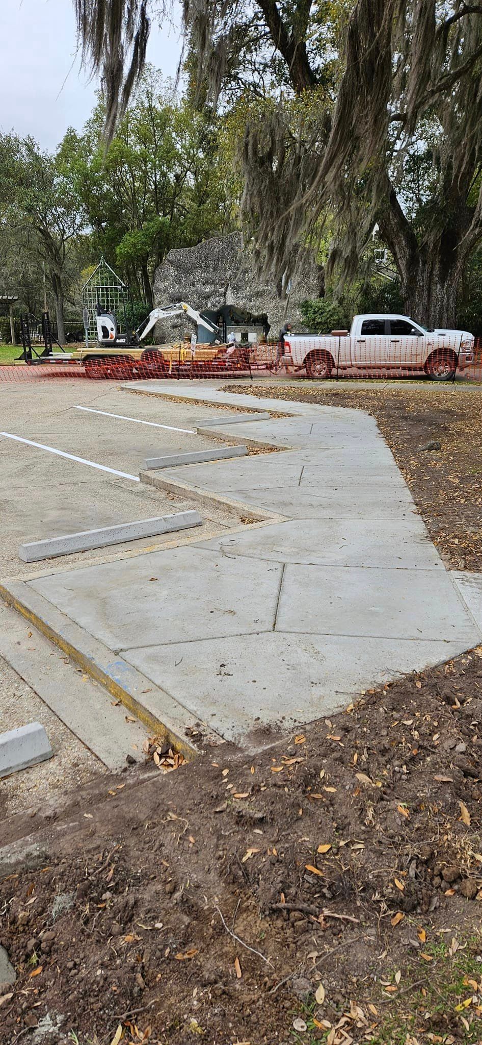 A white truck is parked in a parking lot.