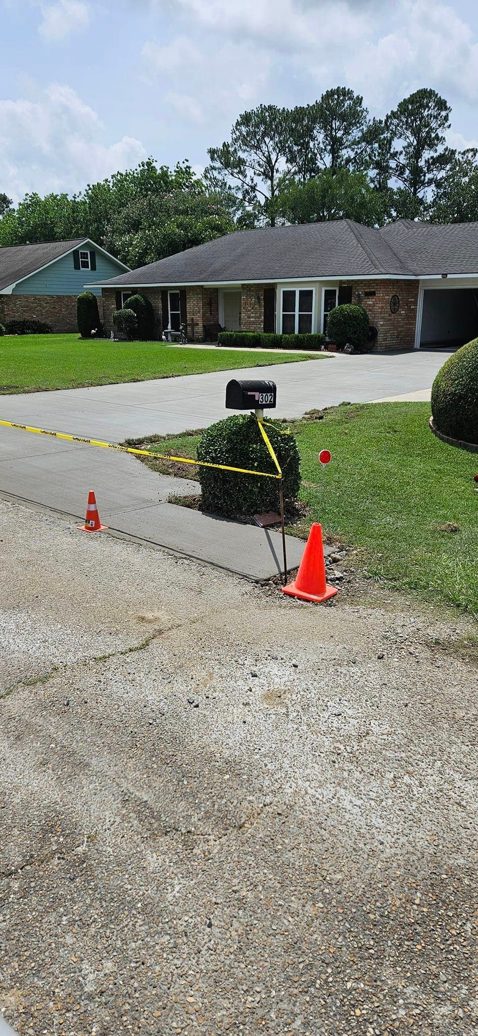 A house with a gravel driveway and a mailbox in front of it.