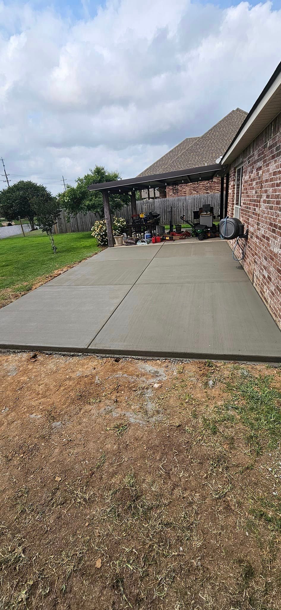 A concrete driveway is being built in front of a house.