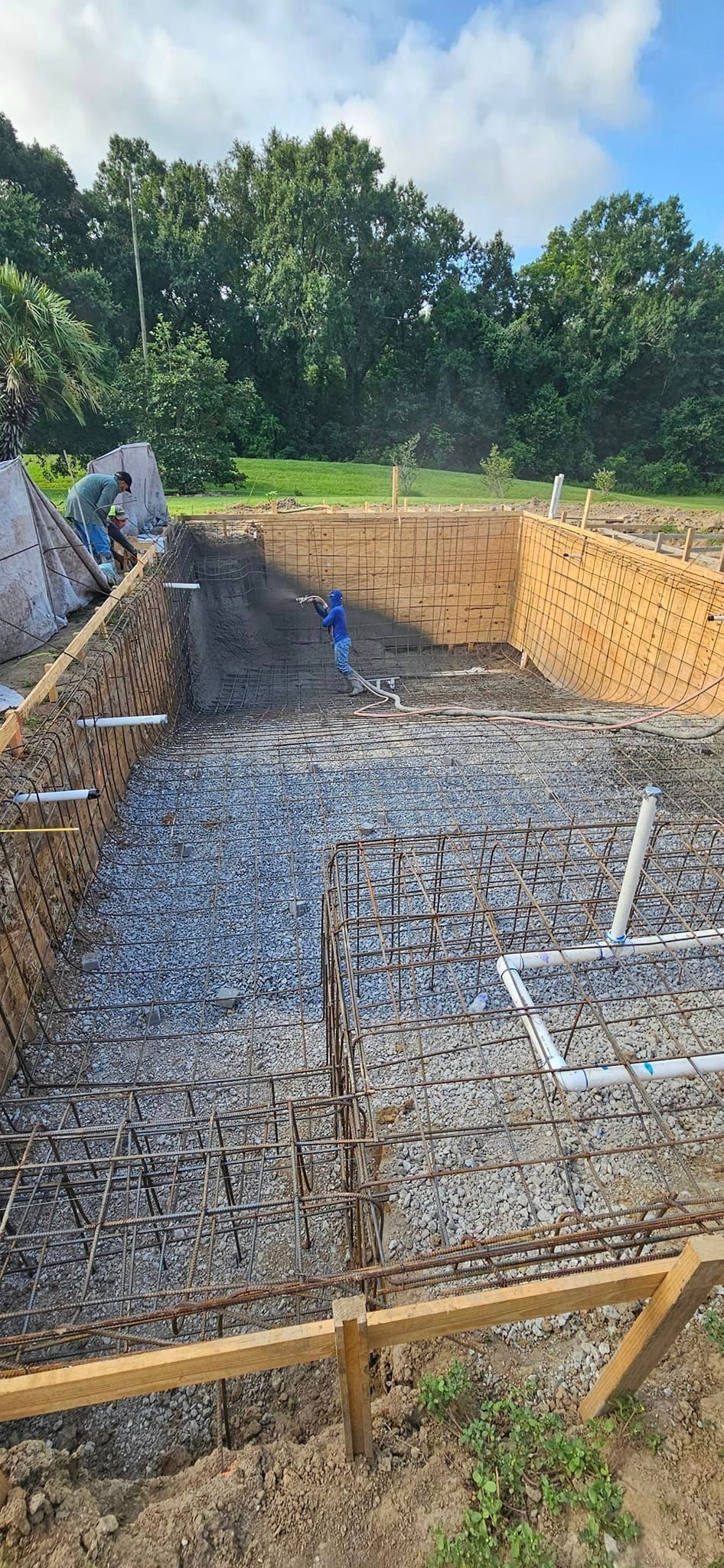 A swimming pool is being built in a backyard.