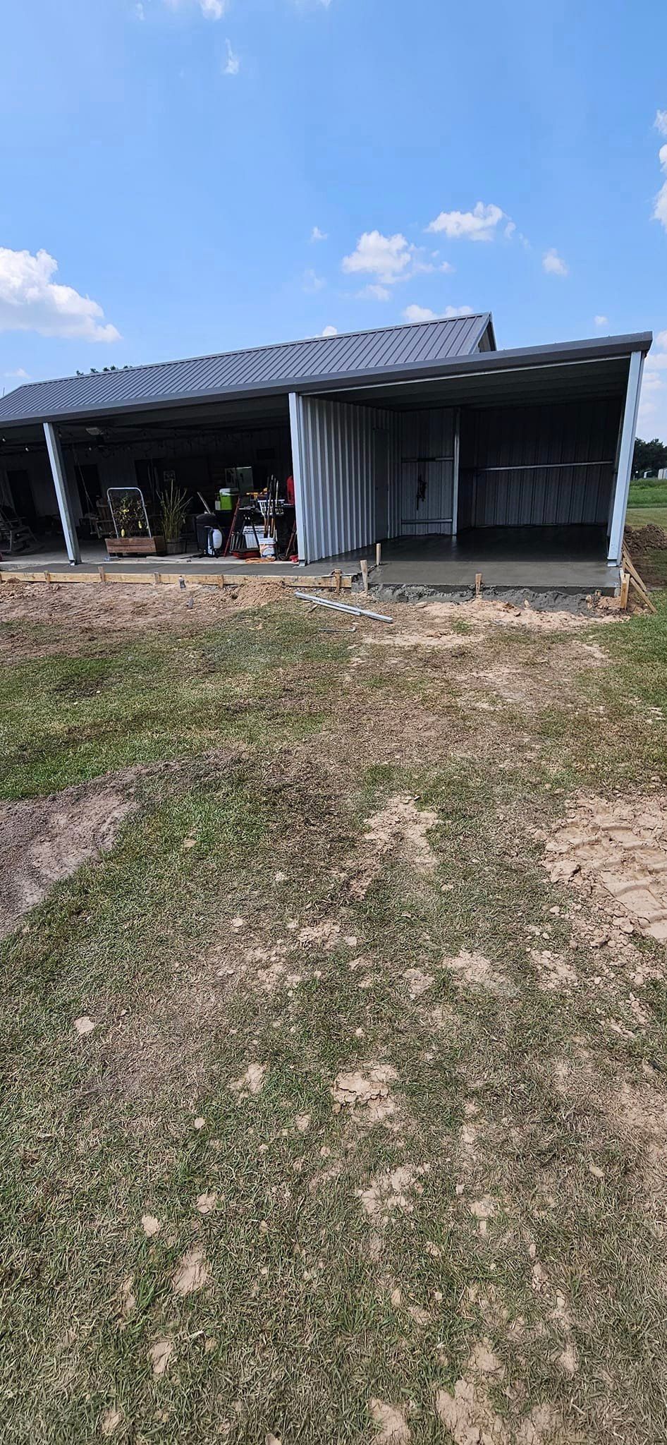 A large building is sitting in the middle of a grassy field.