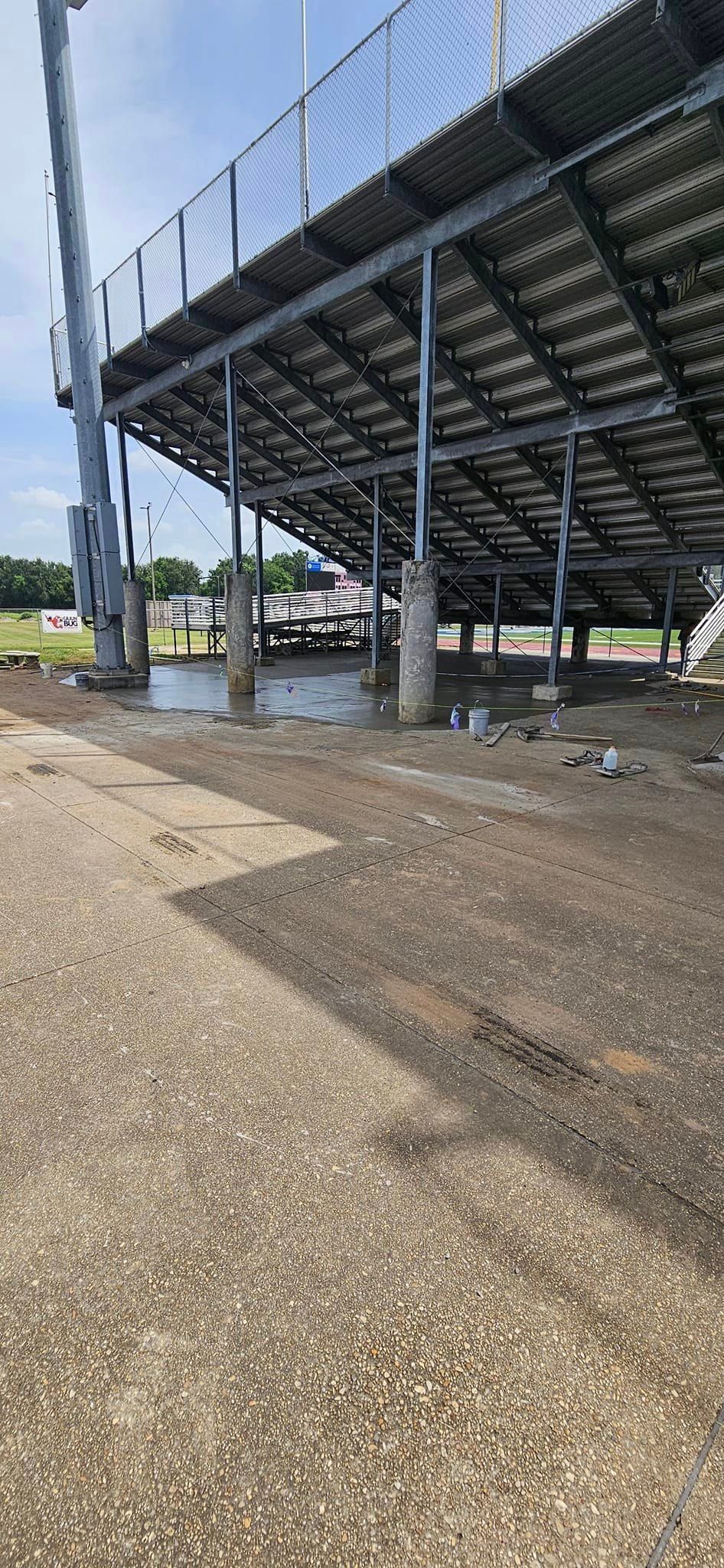 A stadium with a lot of bleachers and a fence around it.