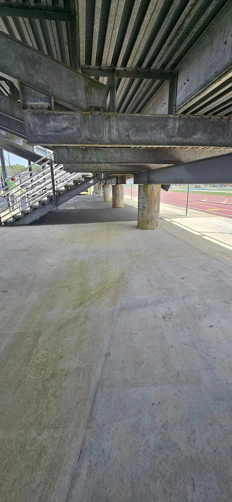 The underside of a bridge with a lot of metal beams.