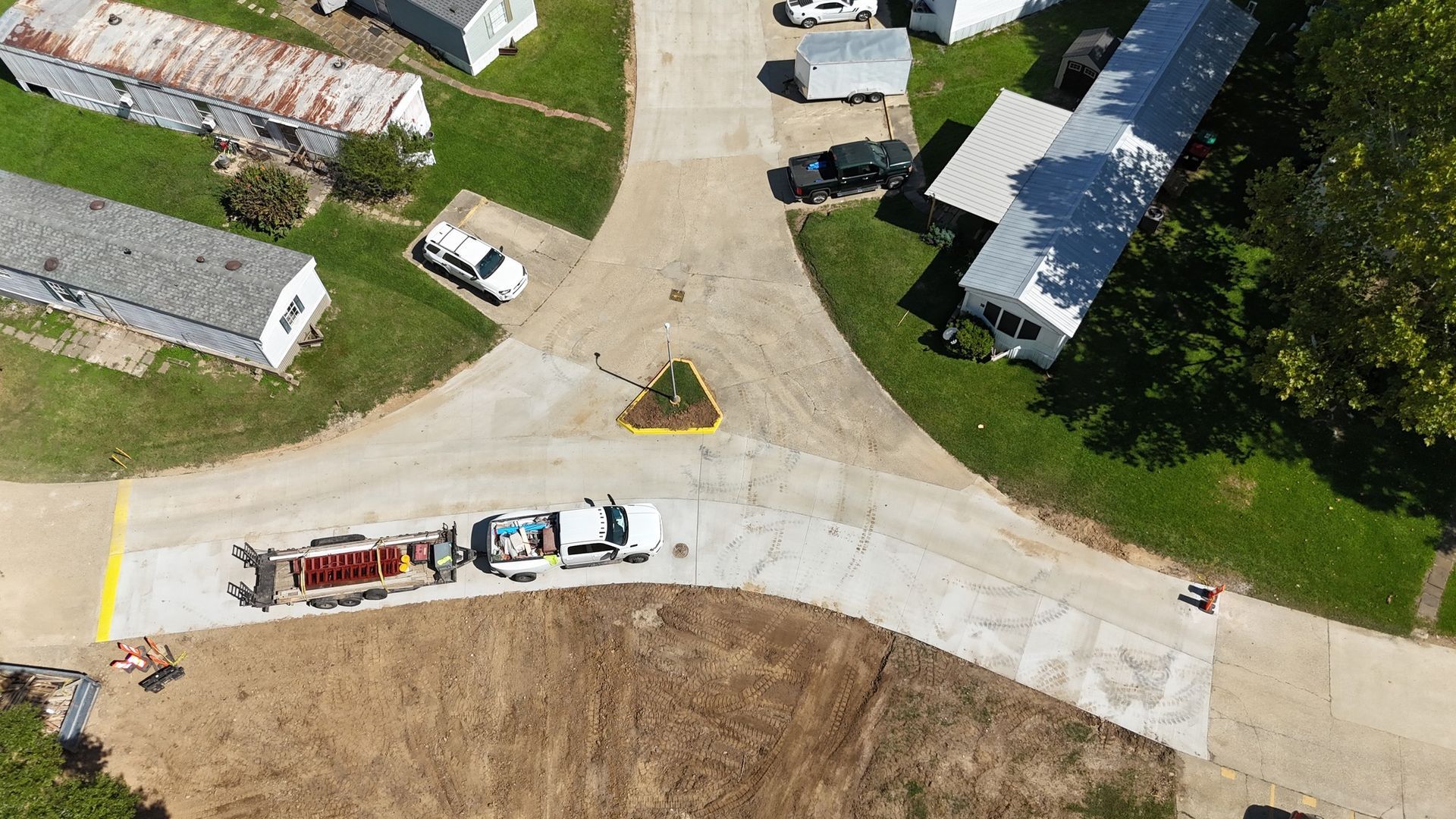 An aerial view of a trailer park with a lot of trailers parked on the side of the road.