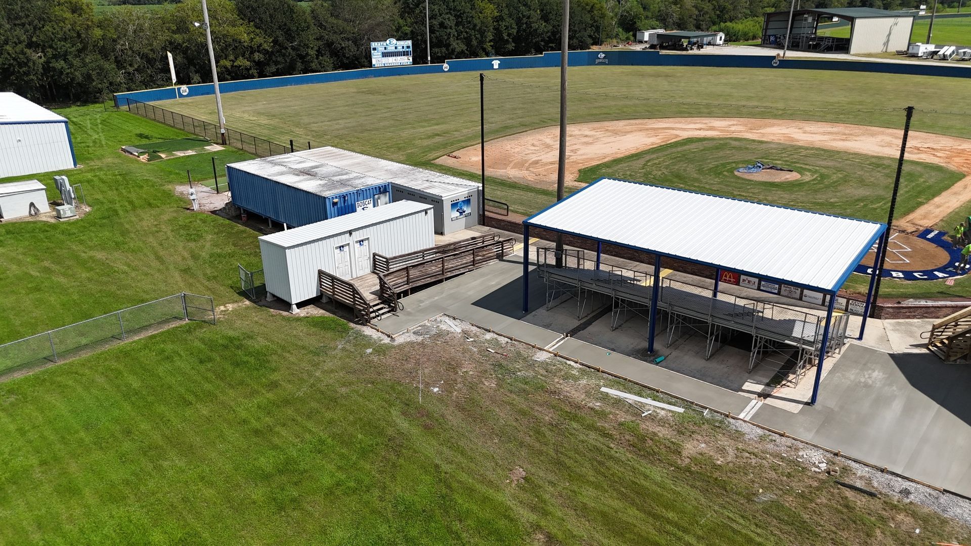 An aerial view of a baseball field with a dugout.
