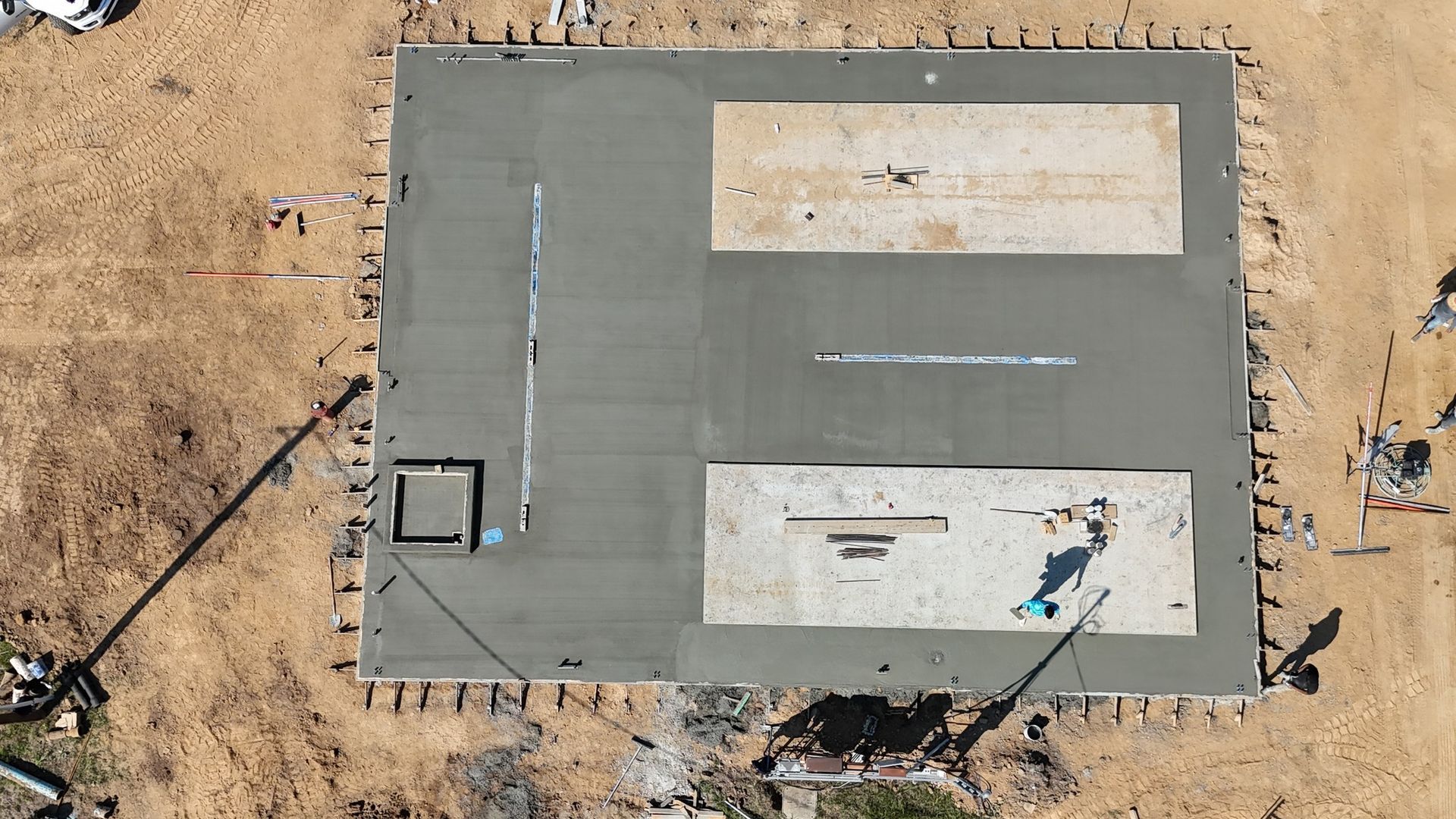 An aerial view of a concrete foundation under construction