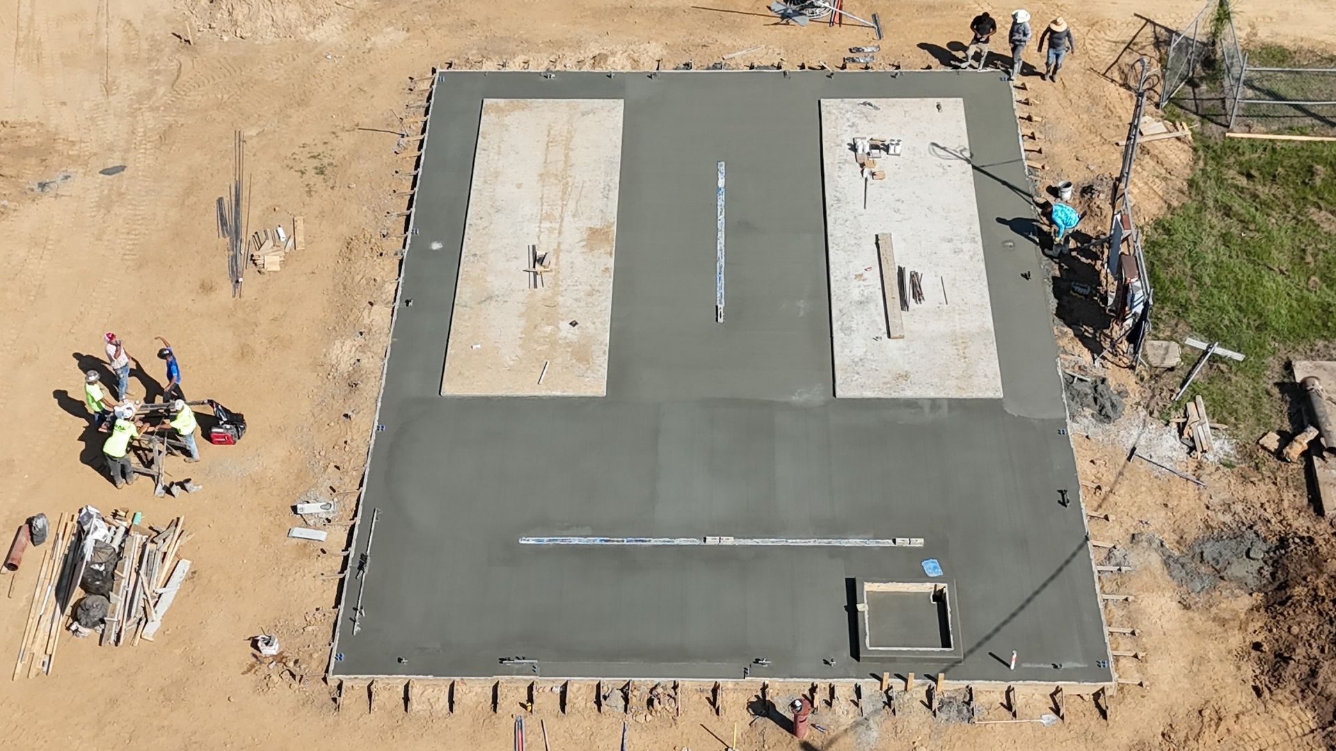 An aerial view of a concrete foundation under construction