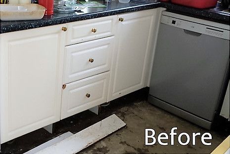 Kitchen cabinets with damage below and a dishwasher, labeled 
