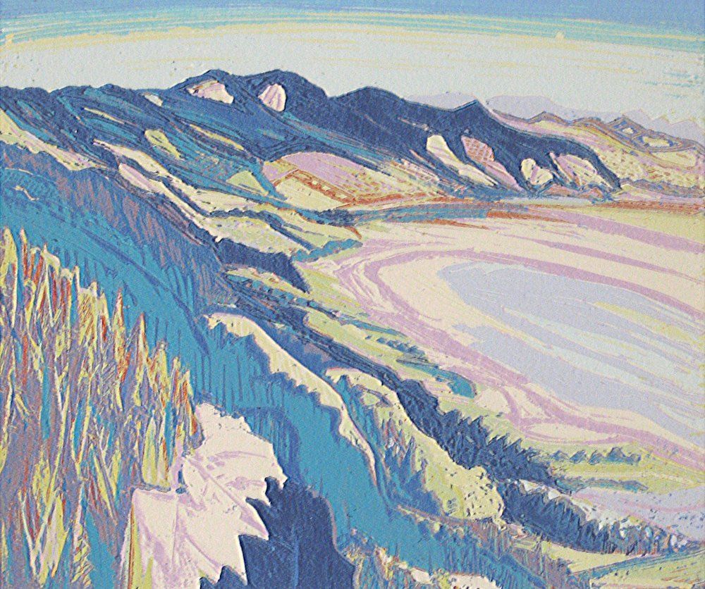 Colorful coastal landscape with mountains, beach, and cliffs