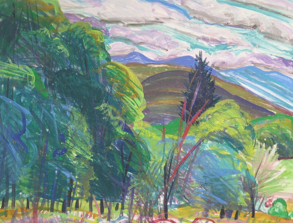 Lush green trees frame a landscape of hills