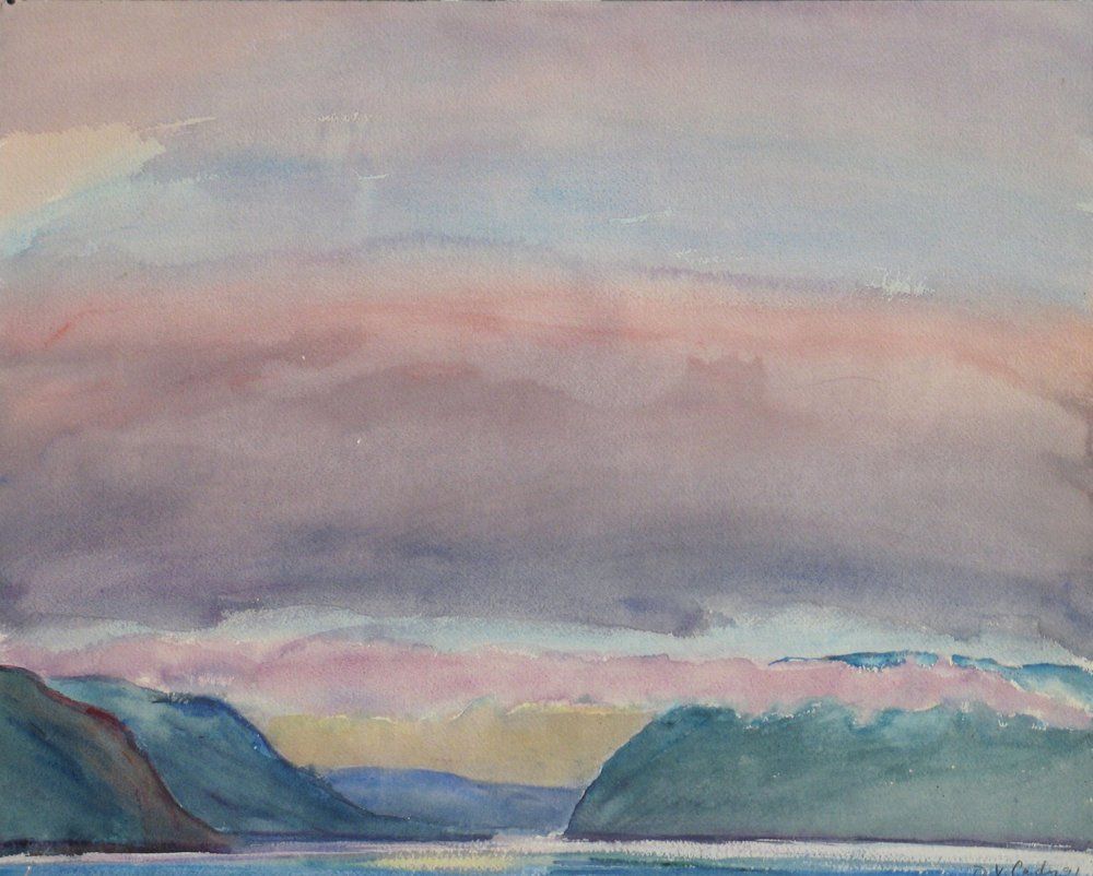 Purple, pink, and blue clouds over green hills and water