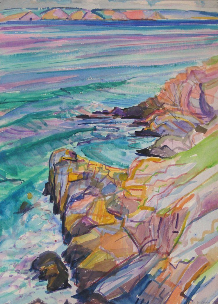 Rocky coast with colorful cliffs, turquoise waves, and a distant hazy shoreline