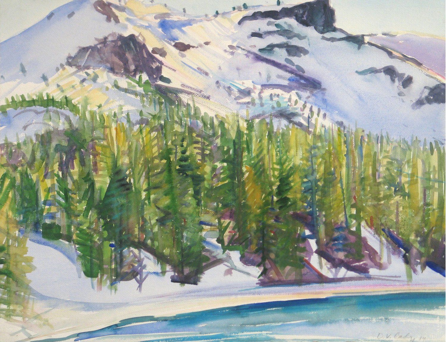 Snow-capped mountain overlooks a forest of green trees next to a blue lake