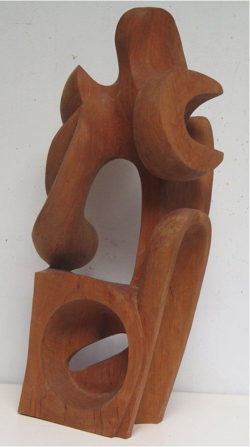 Brown wooden abstract sculpture with a circular cutout in the base and curved shapes