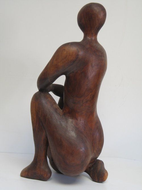 Wooden sculpture of a kneeling person