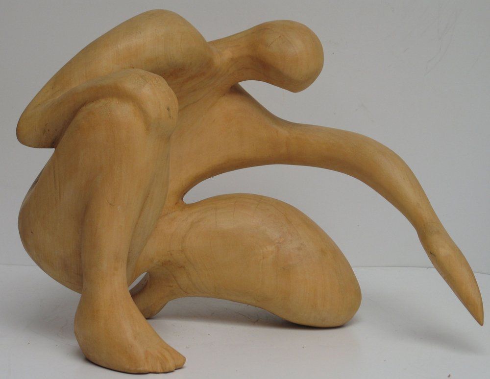 Wooden abstract sculpture of a crouching human figure