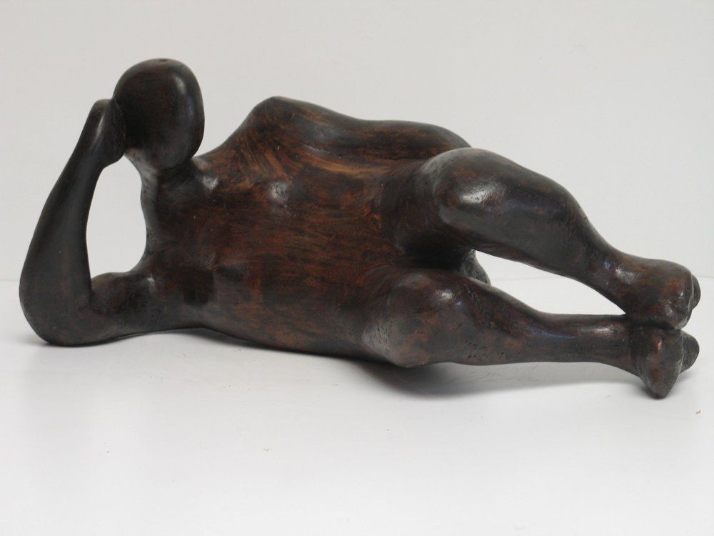 Wooden sculpture of a reclining figure