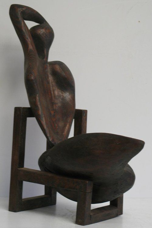 Wooden sculpture of a seated figure