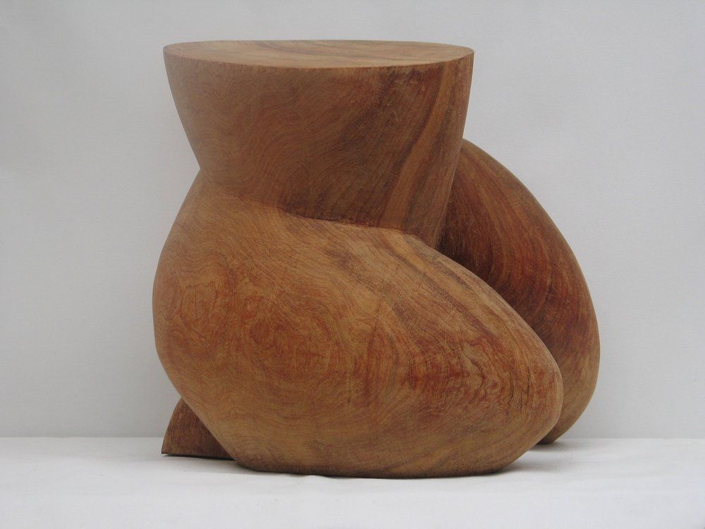 Wooden abstract sculpture of a seated figure