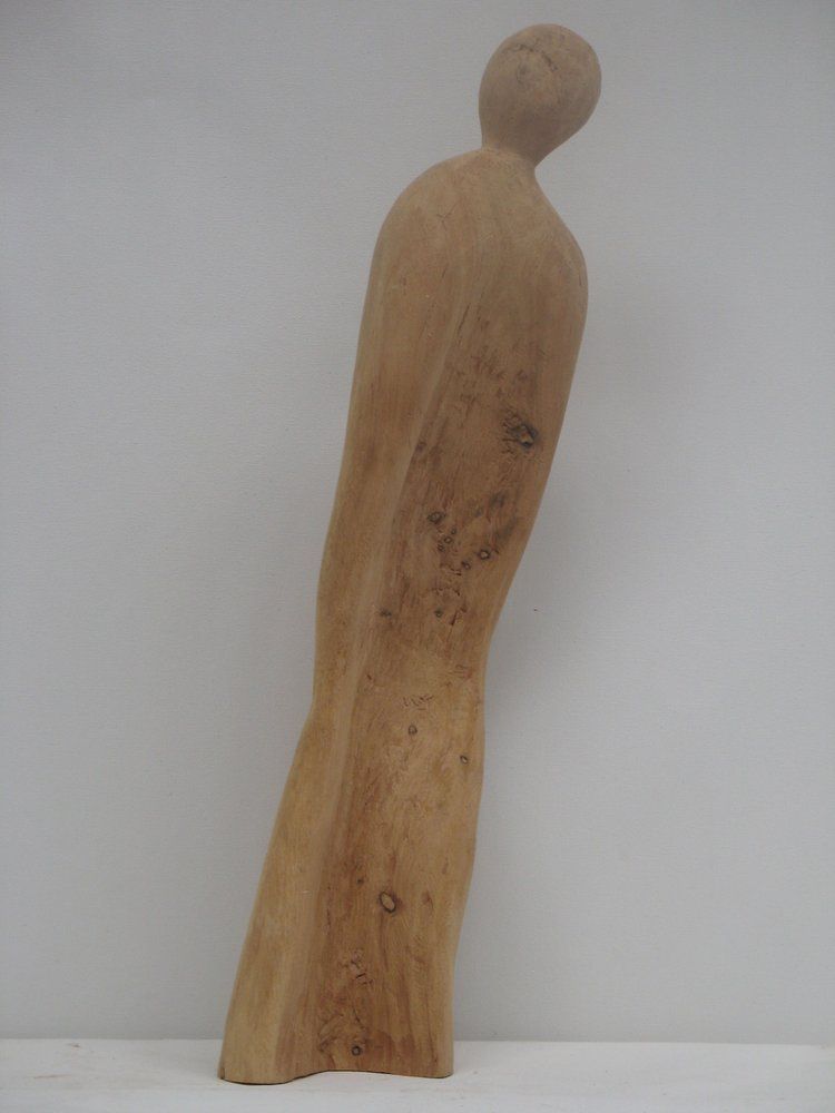 Wooden sculpture of a slender figure