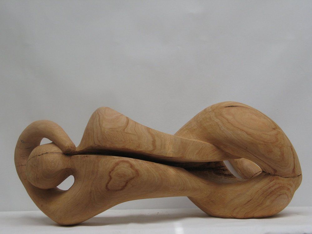 Wooden sculpture of a reclining figure