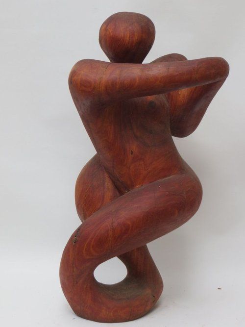 Wooden sculpture of a nude figure in a twisting pose