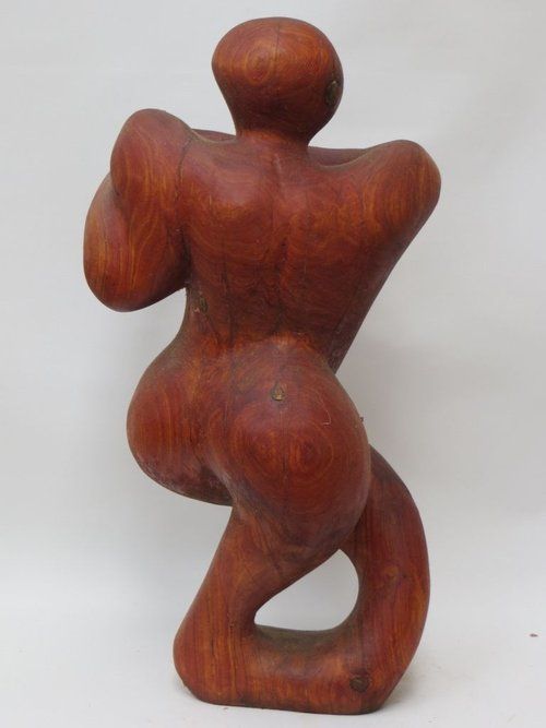 Wooden sculpture of a figure in a twisted pose