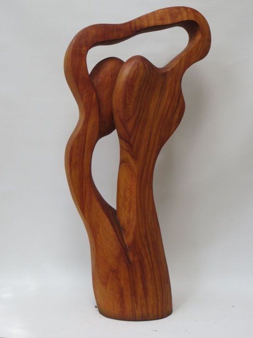 Wooden sculpture of two figures intertwined in a flowing