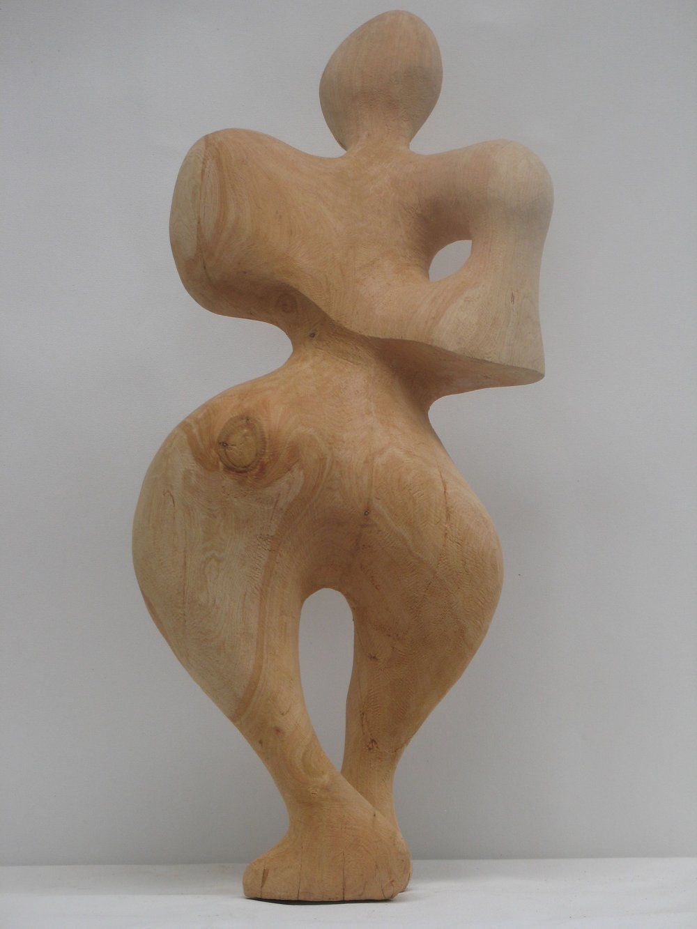 Wooden abstract sculpture of a human figure