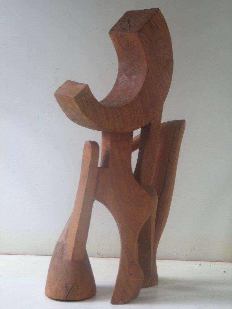 Wooden abstract sculpture of a figure with curved shapes
