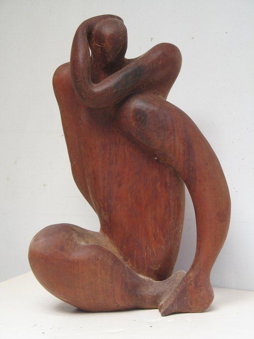 Wooden sculpture of a seated figure