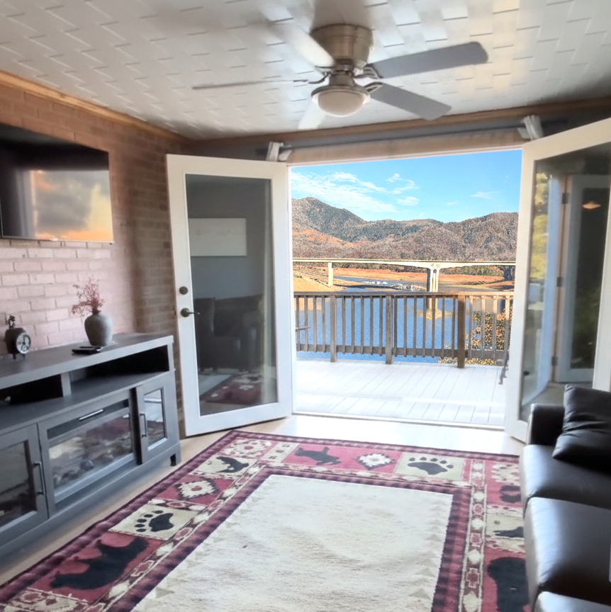 A small house is sitting on top of a dirt hill with a rainbow in the background.