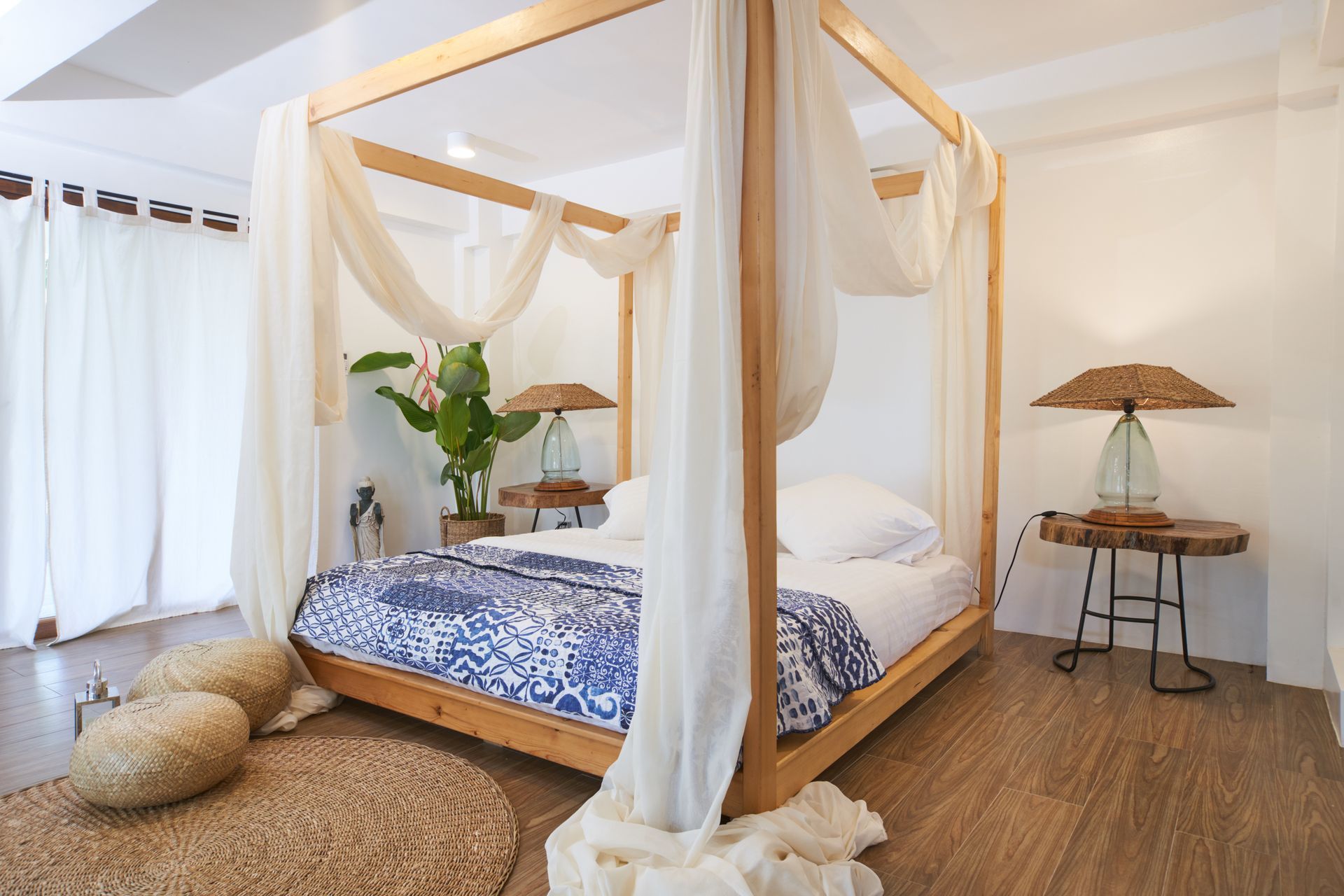 A bedroom with a canopy bed and a table