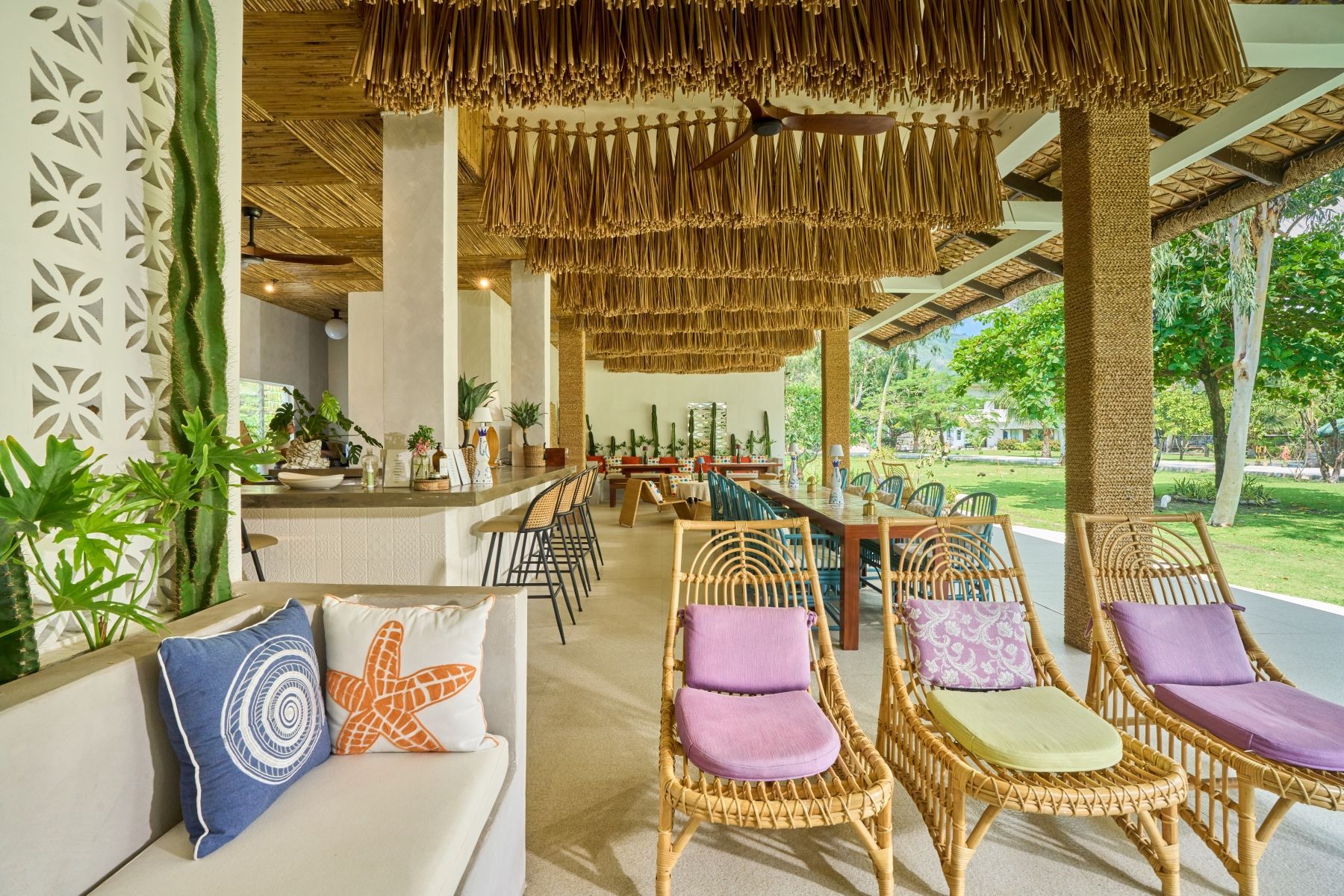 A living room with a couch , chairs , and a table.