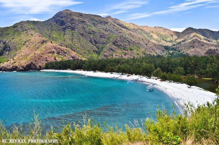 A picture of a beach with mountains in the background