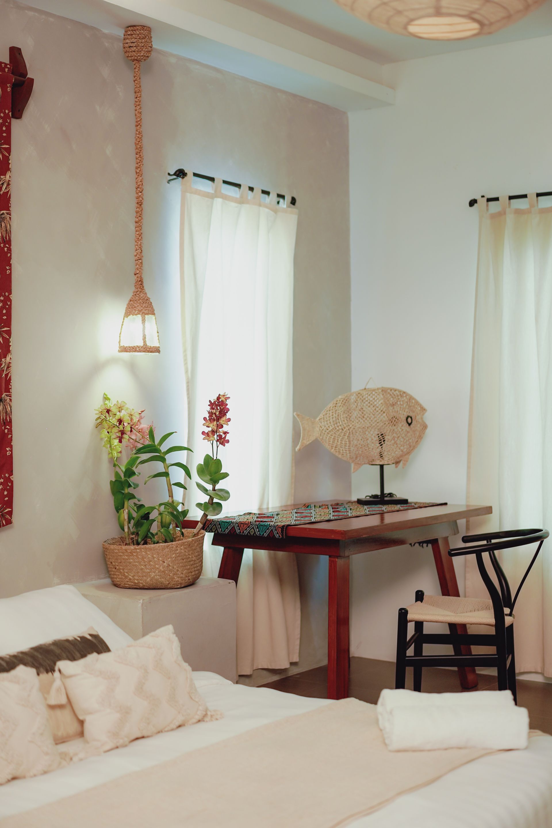 A bedroom with a bed a table and a chair