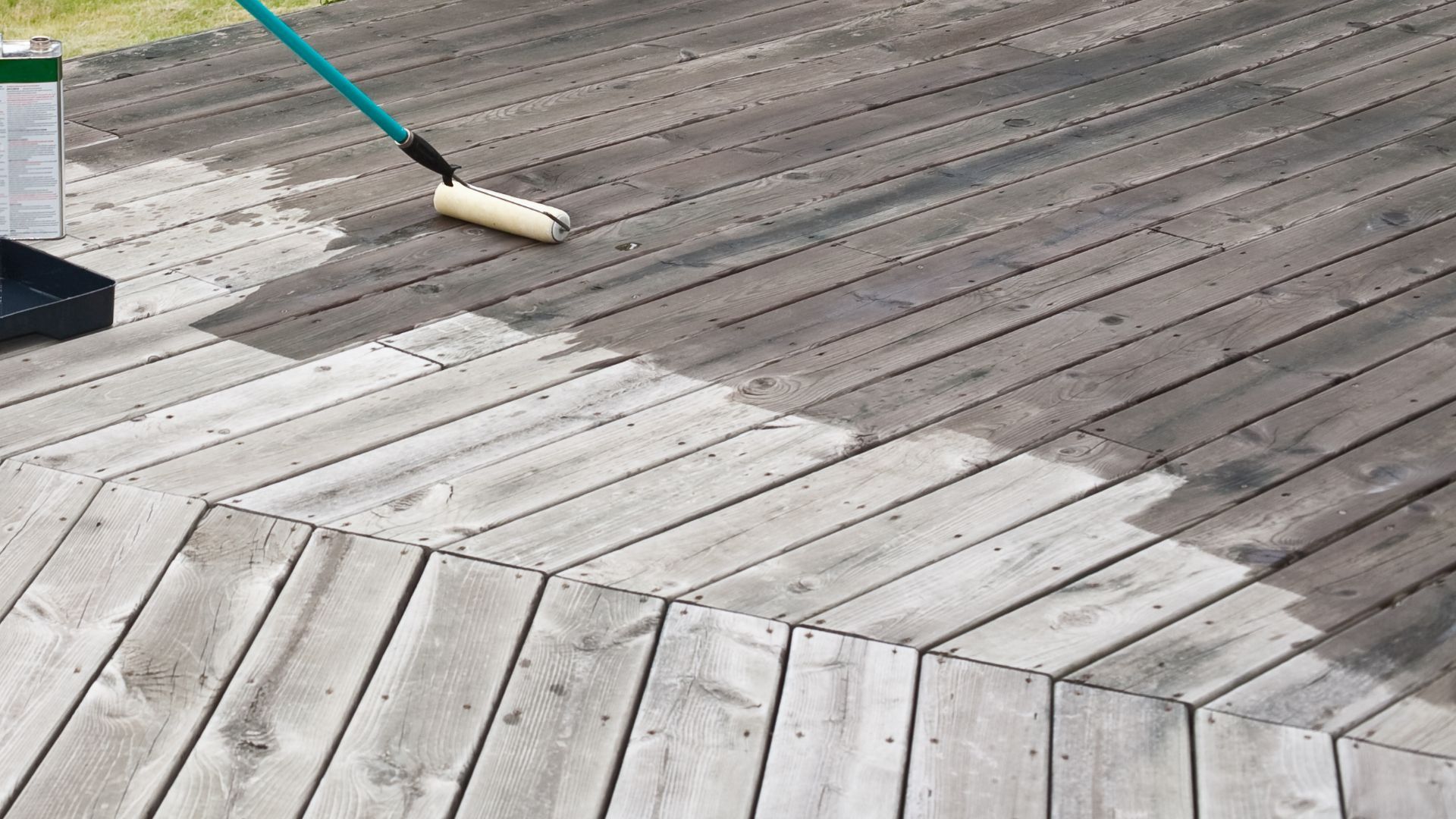 Applying sealant to a wooden deck for waterproofing in Lexington, KY.