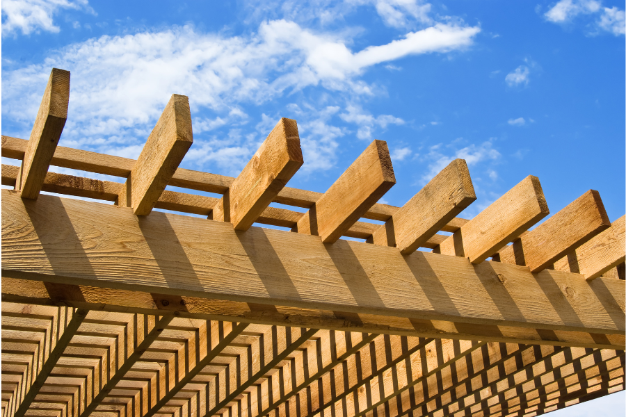 A phot of a strongly built pergola. In the photo, you can see the rugged and secure frame of the pergola and tell that it is properly built.