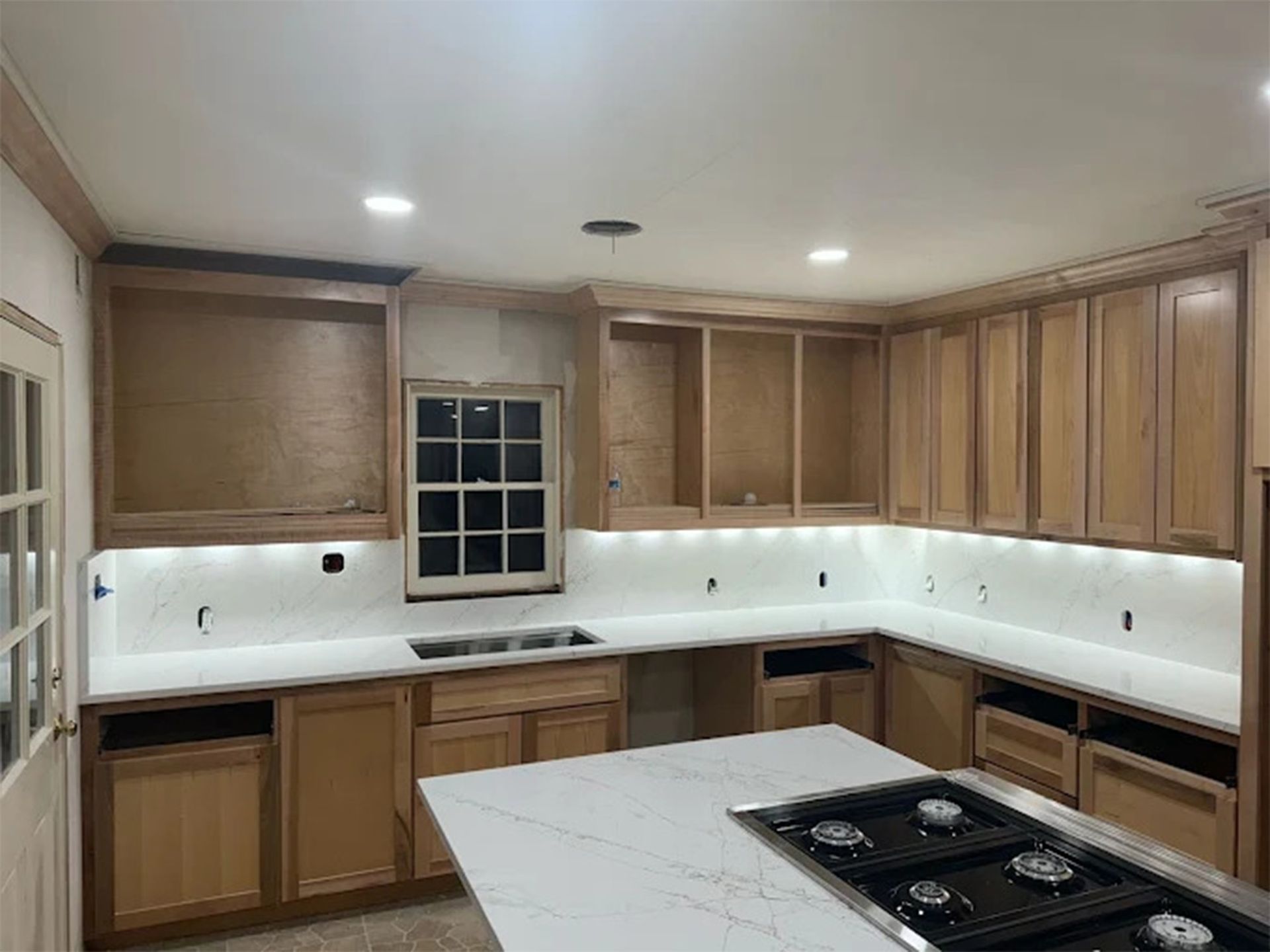 There is a large island in the middle of the kitchen.